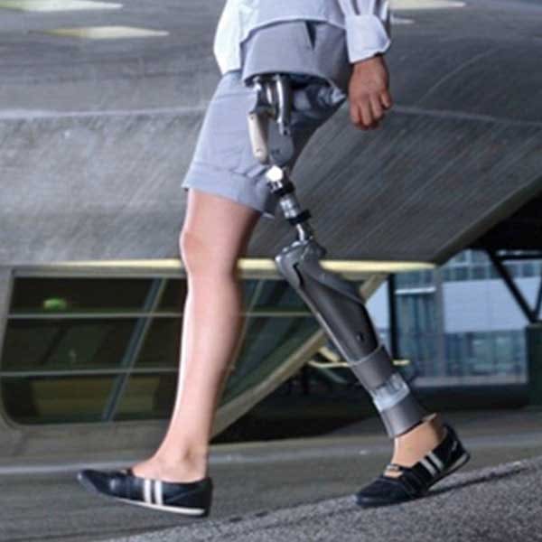 A woman using a hip disarticulation prosthesis walking outdoors
