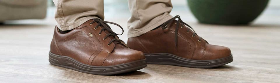 Men's brown leather lace-up diabetic shoes, worn indoors